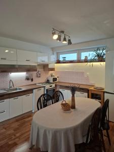 a kitchen with a table and chairs in a kitchen at Chalupa u Strakov in Lúčky +16 photos