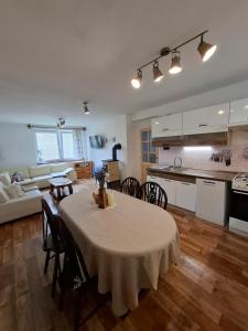 a kitchen and a living room with a table and chairs at Chalupa u Strakov in Lúčky
