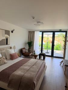 a bedroom with a large bed and a large window at Zambujal Suites in Sesimbra +193 photos