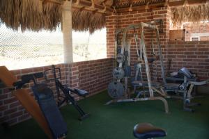 a gym with several tread machines in a brick wall at Baja69 Eco friendly Boutique stay in El Pescadero