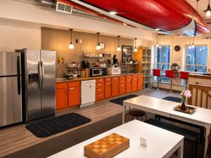 a kitchen with a stainless steel refrigerator and wooden cabinets at Hostel du Nord in Duluth