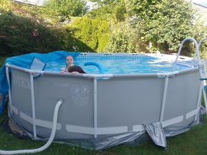 a woman is laying in a pool in a inflatable at Chambre spacieuse, piscine et confort d'une maison in Les Bois