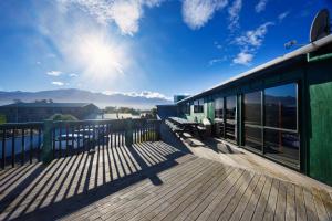 a train on a deck with a view of the mountains at Dusky Lodge in Kaikoura