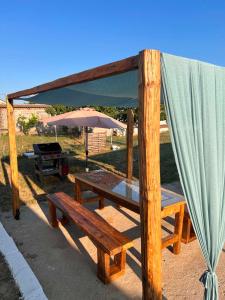 a picnic table with a tent and a grill at Villa Harmony in Xanthi