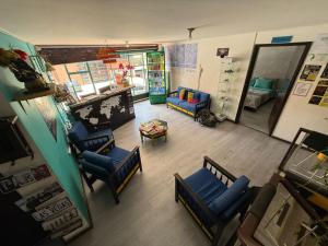 an overhead view of a living room with blue chairs at 82Hostel in Bogotá