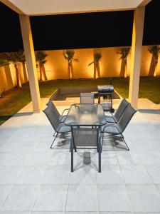 a group of chairs and a table on a patio at Villa Inaya in Tasdert