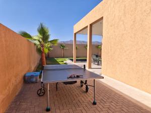 a ping pong table sitting on a brick patio at Villa Inaya in Tasdert