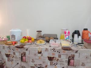 a table with some food on top of it at Capsula Residence Hotel in Marília