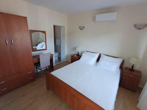 a bedroom with a bed and a desk with a mirror at seafront HOUSE LALA Vinišće in Vinišće