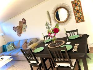 a dining room with a black table and a blue couch at Joselia in Falkenberg