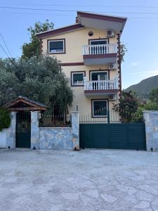 a house with a gate and a fence at Borsh Grove Villa in Borsh