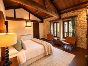 a bedroom with a large bed in a room with wooden ceilings at Elemergia in Irijoa +59 photos