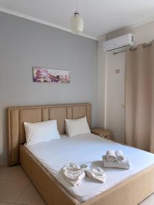 a bedroom with a bed with towels on it at Borsh Grove Villa in Borsh