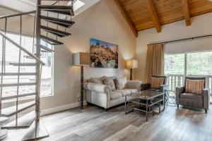 a living room with a couch and a glass table at Western Slope Villa 22 in Mammoth Lakes
