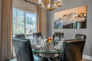 a dining room with a table and chairs and a window at Western Slope Villa 22 in Mammoth Lakes