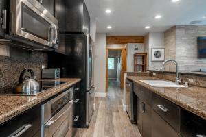 a kitchen with a sink and a counter top at Western Slope Villa 22 in Mammoth Lakes +10 photos
