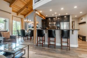 a kitchen and living room with a bar with black chairs at Western Slope Villa 22 in Mammoth Lakes