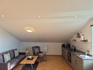 a living room with a couch and a table at Monteurswohnung Bredstedt in Bredstedt