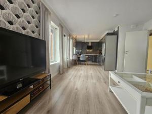 a large living room with a large flat screen tv at Hillegård 6E in Lærdalsøyri