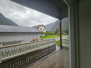 a balcony with a view of a house at Hillegård 6E in Lærdalsøyri