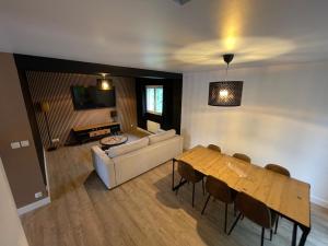 a living room with a couch and a table at La Guignicourtoise in Guignicourt