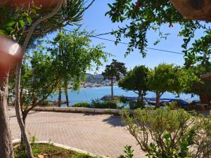 a brick walkway with a view of the water at Spacious Apartment Garden View Partial Seaview in Makry Gialos