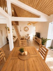 a dining room with a wooden table and chairs at Le KOZY, LULU, FAR FAR in Saint-Joseph