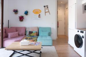 a living room with a couch and a table at Casa Naranjo - Plaza Mayor Almagro in Almagro