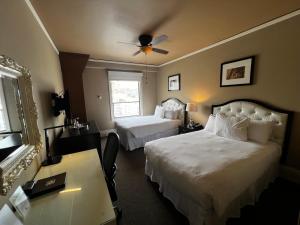 a hotel room with two beds and a desk at Kensington Park Hotel in San Francisco +62 photos