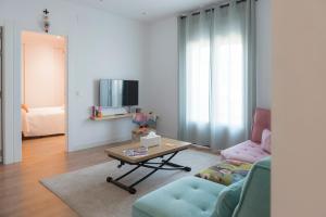 a living room with a couch and a coffee table at Casa Naranjo - Plaza Mayor Almagro in Almagro