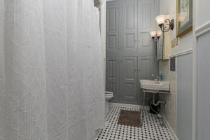 a bathroom with a toilet and a sink and a shower at 1895 Victorian Home on Historic Walnut Street in Springfield