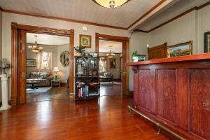 a living room with a hard wood floor and a room at 1895 Victorian Home on Historic Walnut Street in Springfield
