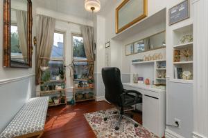 a home office with a desk and a chair at 1895 Victorian Home on Historic Walnut Street in Springfield +38 photos