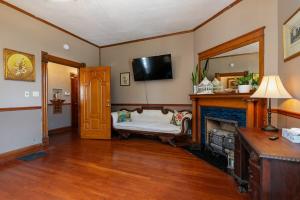 a living room with a couch and a fireplace at 1895 Victorian Home on Historic Walnut Street in Springfield