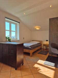 a bedroom with a bed and a desk and a window at Monteurswohnung Bredstedt in Bredstedt