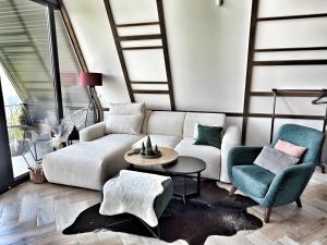 a living room with a couch and two chairs at Jahorina Luxury Chalets in Jahorina +46 photos