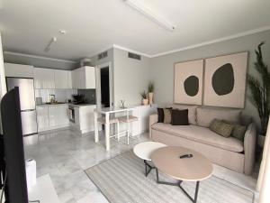 a living room with a couch and a table at Suite Room 33 Ioannina - Near airport in Ioannina
