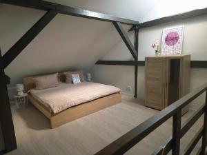 a bedroom with a bed and a dresser in a attic at Ferienidyll an der Recknitz in Tessin