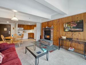 a living room with a couch and a fireplace at Mountain Green Resort in Killington Village