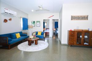 a living room with a blue couch and a table at E' Nauwi Beach Resort in Port Vila