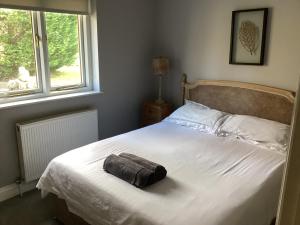 a bed with a towel on it in a bedroom at Tarn View in Winster