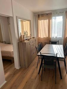 a dining room with a table and chairs and a bedroom at Happy Beautiful Home in Cholet