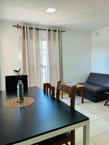a living room with a table and a couch at Departamento Centrico Iguazu 2A in Puerto Iguazú