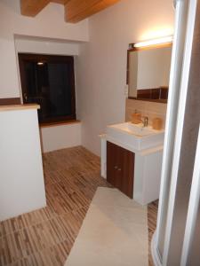 a bathroom with a sink and a mirror at Apartment U Lochů in Kňovičky