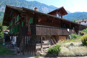 a large wooden house with green shuttered windows at Lakeview Chalet 1 , Drligen in Därligen