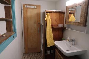 a bathroom with a sink and a mirror and a door at Lakeview Chalet 1 , Drligen in Därligen