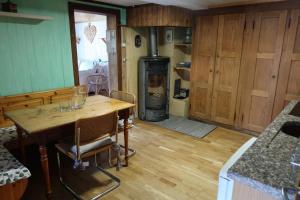 a kitchen with a wooden table and a stove at Lakeview Chalet 1 , Drligen in Därligen