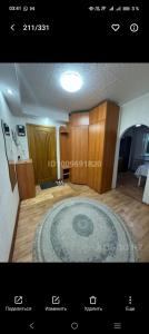 a room with a large rug on a wooden floor at Уютный уголок in Aktobe +3 photos