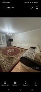 a picture of a bedroom with a bed with a rug at Уютный уголок in Aktobe