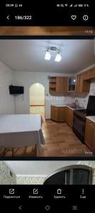 a view of a kitchen with a table and a kitchen at Уютный уголок in Aktobe